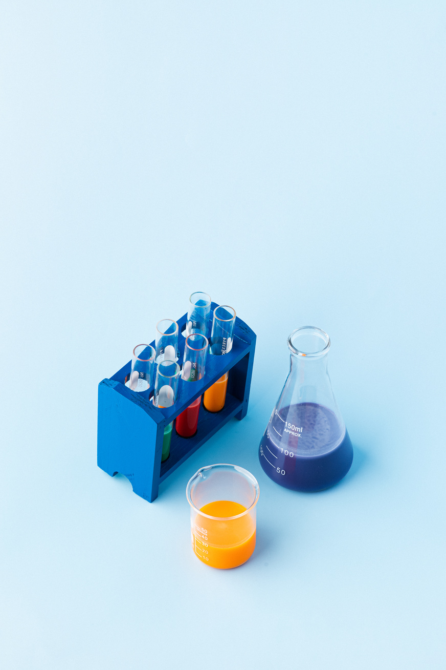 Laboratory Apparatus with Liquids on Blue Background